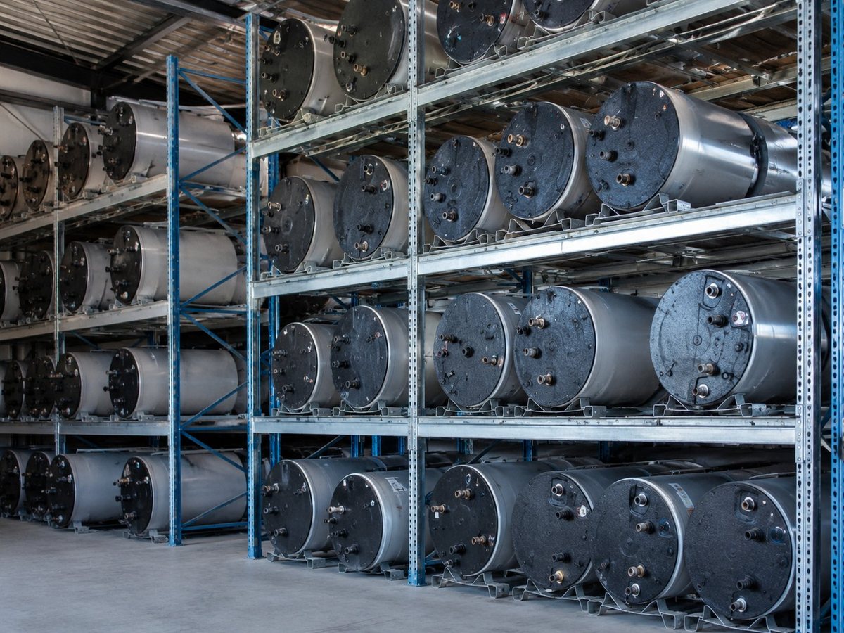 Salvaged geyser cylinders organised on warehouse shelving